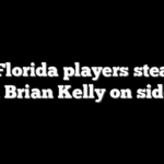 LSU, Florida players steamroll coach Brian Kelly on sidelines