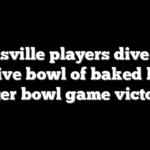 Louisville players dive into massive bowl of baked beans after bowl game victory