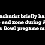 Parachutist briefly hangs above end zone during Armed Forces Bowl pregame mishap