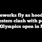 Fireworks fly as hooded protesters clash with police after Olympics open in Milan