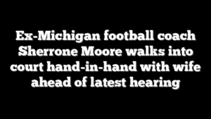 Ex-Michigan football coach Sherrone Moore walks into court hand-in-hand with wife ahead of latest hearing