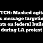 WATCH: Masked agitator sprays message targeting ICE agents on federal building during LA protest