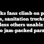Knicks fans climb on police cars, sanitation trucks as countless others unable to get into jam-packed parade